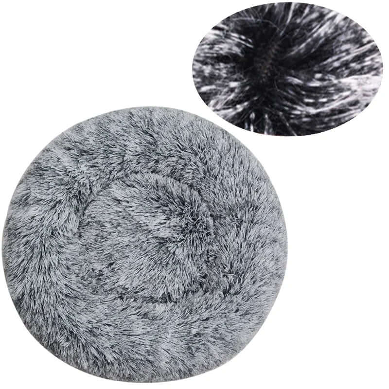 Soft gray round pet bed made of plush fur for small to large dogs and cats, providing warmth and comfort.