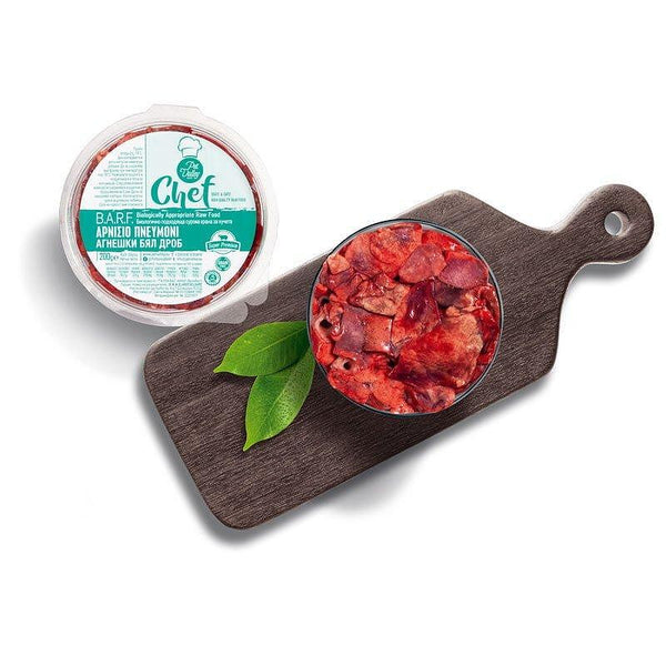 BoneBarf Agneška bial drob in a bowl on a wooden cutting board with green leaves