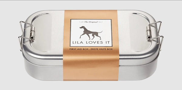 Metal first aid box for dogs, labeled 'Lila Loves It', essential for pet injury care.